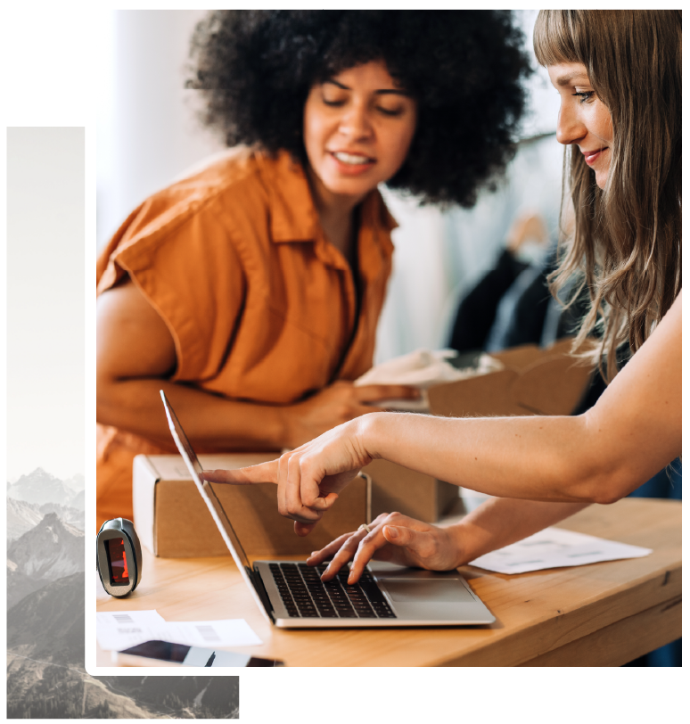 2 women at a laptop building an order